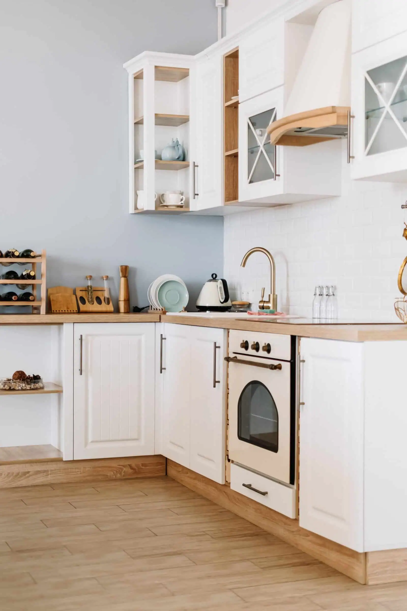 Modern white kitchen with wooden accents and minimalist design elements.